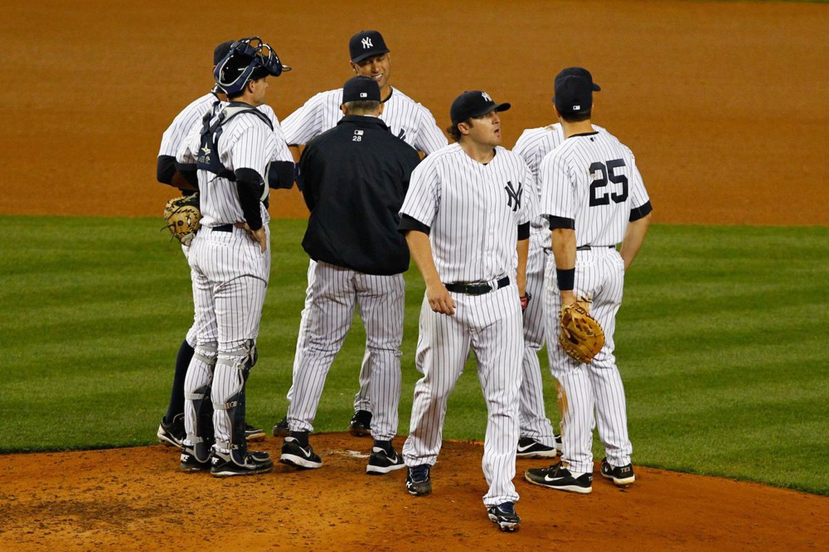 New York Yankees manager Joe Girardi (28) removes starting pitcher Phil Hughes (65) from the game during the sixth inning against the Baltimore Orioles at Yankee Stadium. Orioles won 7-1. Debby Wong-US PRESSWIRE
