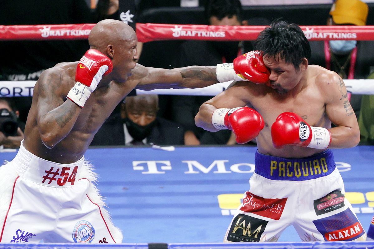 Yordenis Ugas (L) hits Manny Pacquiao in the sixth round of their WBA welterweight title fight at T-Mobile Arena on August 21, 2021 in Las Vegas, Nevada. Ugas retained his title by unanimous decision.