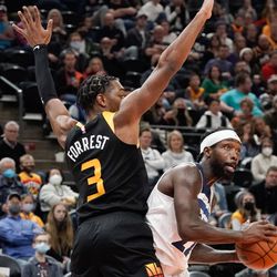 Minnesota Timberwolves guard Patrick Beverley, right, looks to pass past Utah Jazz guard Trent Forrest during an NBA game at Vivint Arena in Salt Lake City on Friday, Dec. 31, 2021.