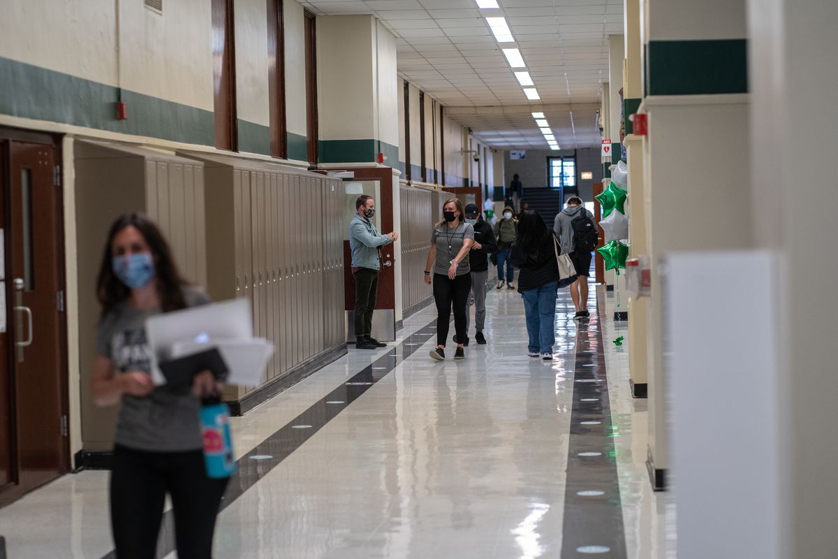 Staff and students walk the halls of Senn High School on the first week back to classrooms on April 23, 2021.