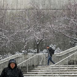 University of Utah students walk through the snow near the Marriott Library in Salt Lake City on Wednesday, Dec. 12, 2018.