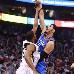 Utah Jazz forward Derrick Favors (15) works to defend Oklahoma City Thunder center Enes Kanter (11) as the Jazz and the Thunder play at Vivint Smart Home arena in Salt Lake City on Wednesday, Dec. 14, 2016.
