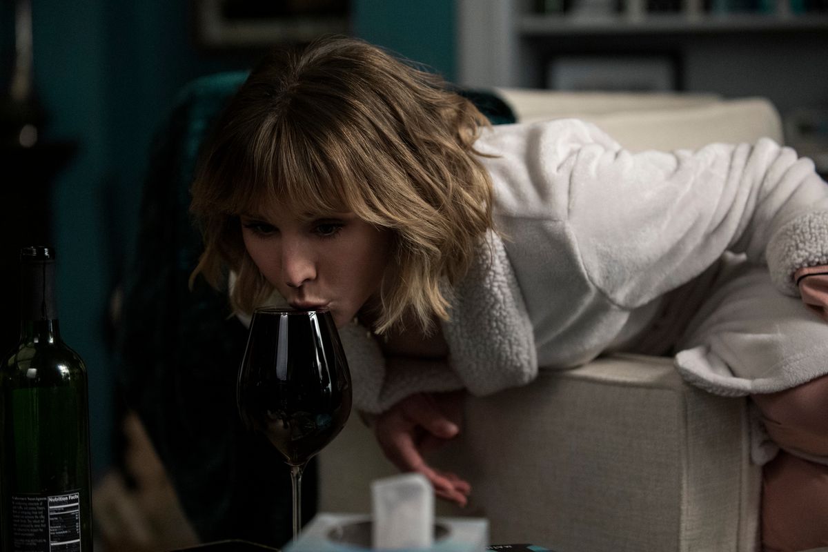 kristen bell lapping wine from a wine glass