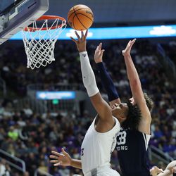 Weber State Wildcats forward Dillon Jones (2) drives on Brigham Young Cougars forward Caleb Lohner (33) in Ogden on Saturday, Dec. 18, 2021. BYU won 89-71.
