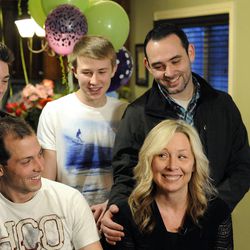 Nanette Wride, wife of fallen Utah County Sgt. Cory Wride, has a laugh about how she and Cory met while sitting with her sons Shea Wride (top left), Tyesun Wride (top center), Nathan Mohler (top right) and Chance Wride (left) at their home on Sunday, February 2, 2014.