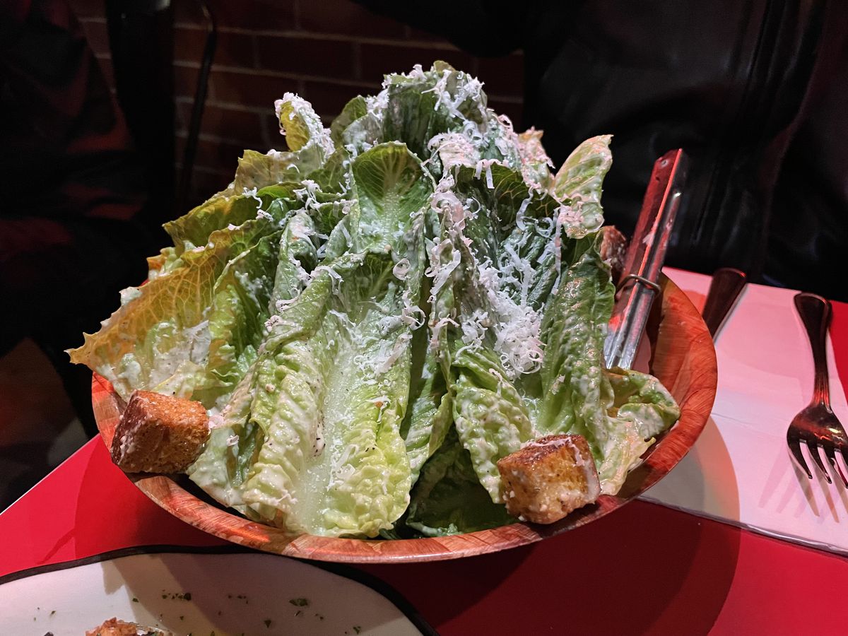 The Caesar salad at Bernie’s, served with tongs.