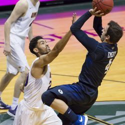 Northern Iowa guard Paul Jesperson, top left, looks on as BYU guard Nick Emery (4) shoots over Northern Iowa guard Jeremy Morgan, center, in the first half of an NCAA college basketball game at the Diamond Head Classic, Friday, Dec. 25, 2015, in Honolulu. (AP Photo/Eugene Tanner)