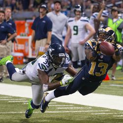 St. Louis Rams wide receiver Chris Givens (13) has the ball slip through his hands as Seattle Seahawks cornerback Brandon Browner (39) defends during the second half at the Edward Jones Dome.