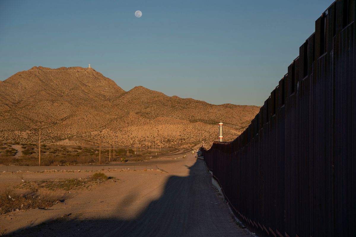 The moon above a hilly stretch of land at the US-Mexico border in New Mexico.