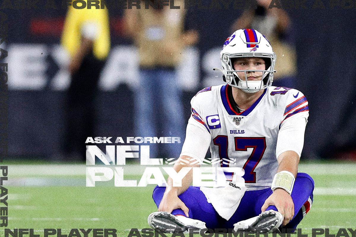 Bills QB Josh Allen sits on the field with a disappointed look on his face