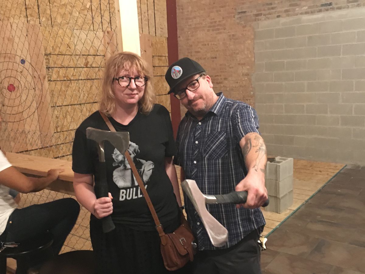 Kate Procter and Chris Russell pose with axes. | Mitch Dudek/Sun-Times