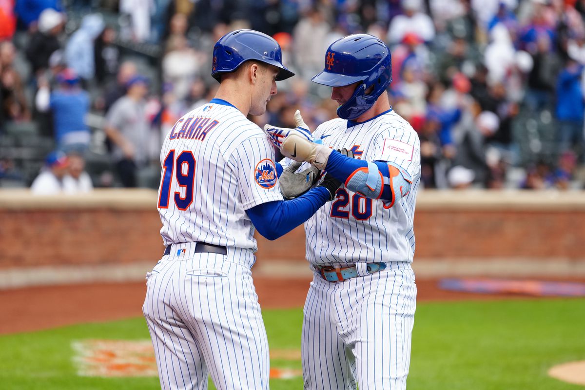 Pete Alonso of the New York Mets celebrates with Mark Canha after hitting a solo home run in the eighth inning during the game between the Miami Marlins and the New York Mets at Citi Field on Friday, April 7, 2023 in New York, New York.