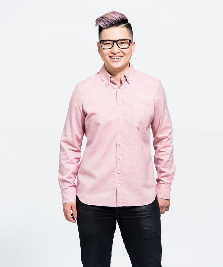 A model wearing glasses and a pink button down shirt