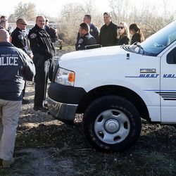 Officials work at the scene where a body was discovered in the Jordan River at 3300 South in Salt Lake City, Monday, Dec. 1, 2014.