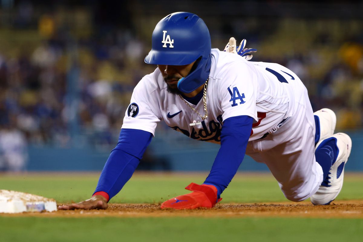 Mookie Betts of the Los Angeles Dodgers dives back to first base during the third inning against the Arizona Diamondbacks in game two of a doubleheader at Dodger Stadium on September 20, 2022 in Los Angeles, California.