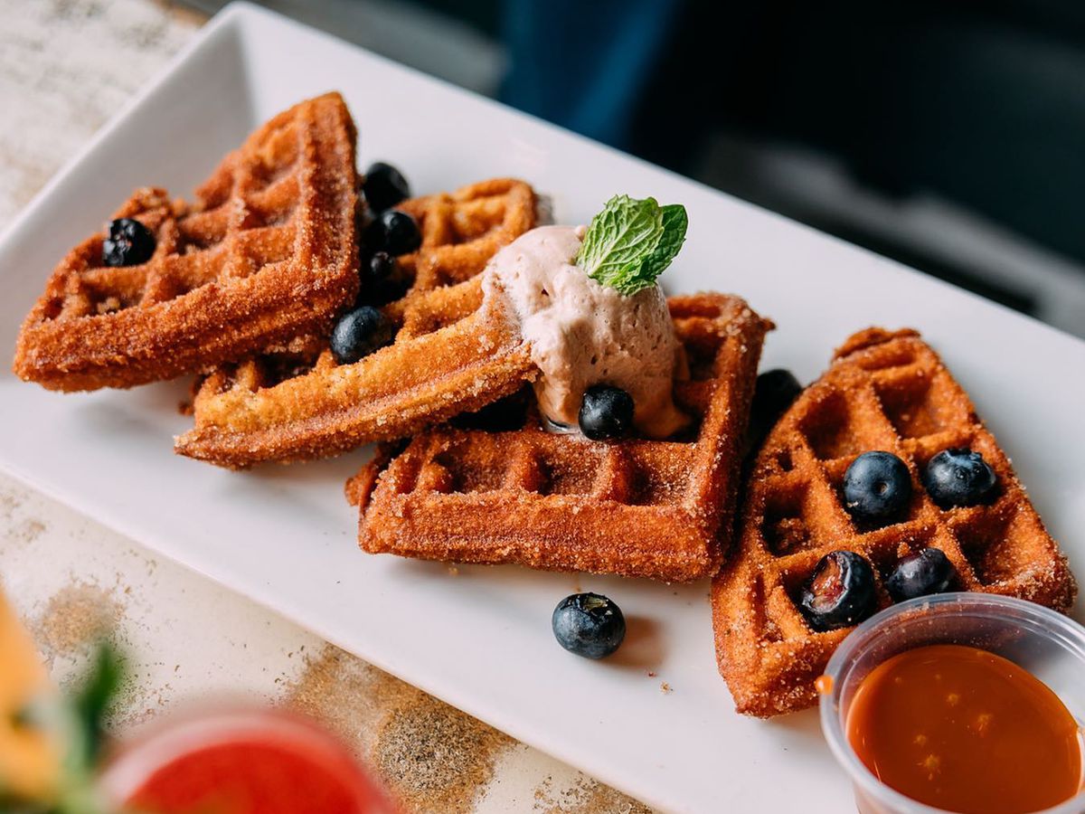 Waffles with blueberries on a square white plate