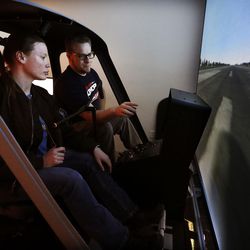 Students Maya Dickemore and Jared Steffen train in a helicopter simulator at the Salt Lake Community College Westpointe Center in Salt Lake City on Wednesday, Dec. 9, 2015.