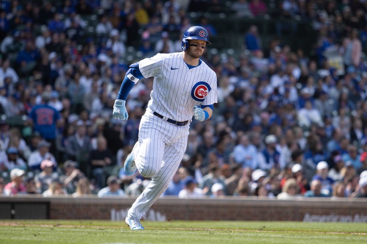 Chicago Cubs left fielder Ian Happ runs to first base during a Major League Baseball game between the Texas Rangers and the Chicago Cubs on April 09, 2023 at Wrigley Field in Chicago, IL.