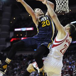 Utah Jazz's Gordon Hayward, left, is fouled by Houston Rockets' Donatas Motiejunas in the second half of an NBA basketball game Wednesday, March 23, 2016, in Houston. The Jazz won 89-87. (AP Photo/Pat Sullivan)