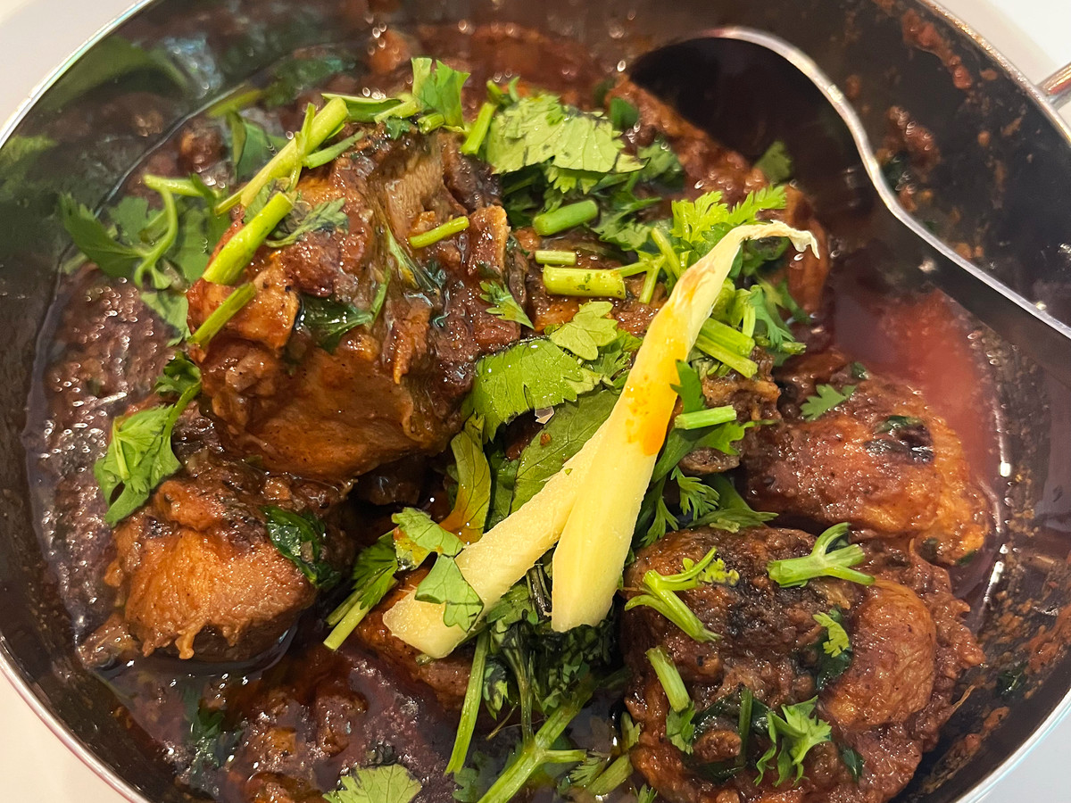A meaty stew topped with cilantro. 