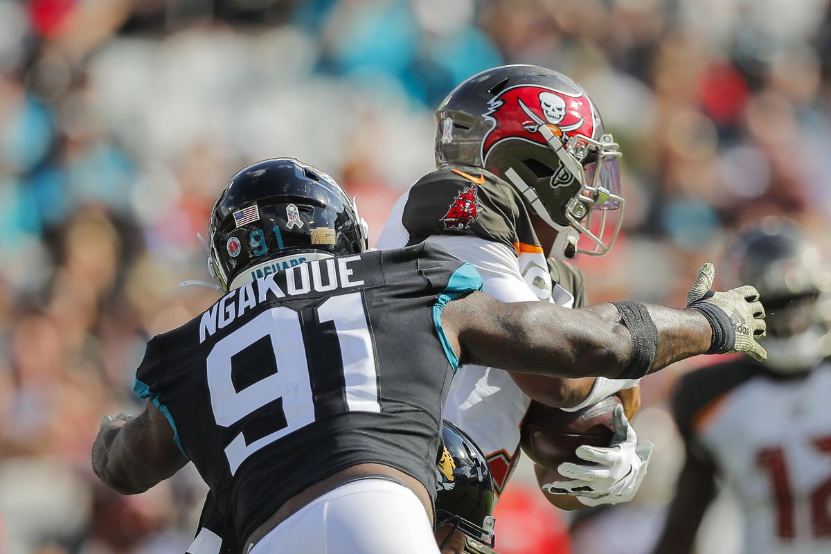 Yannick Ngakoue of the Jacksonville Jaguars tackles Jameis Winston of the Tampa Bay Buccaneers during the second quarter of a game at TIAA Bank Field on December 01, 2019 in Jacksonville, Florida.