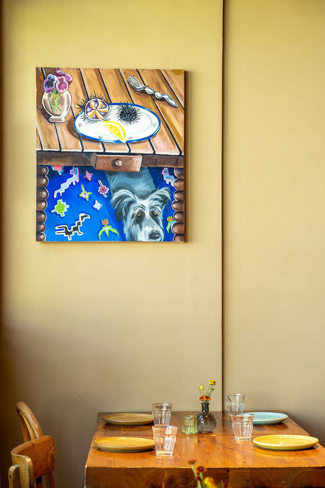 A painting of a dog in a restaurant.