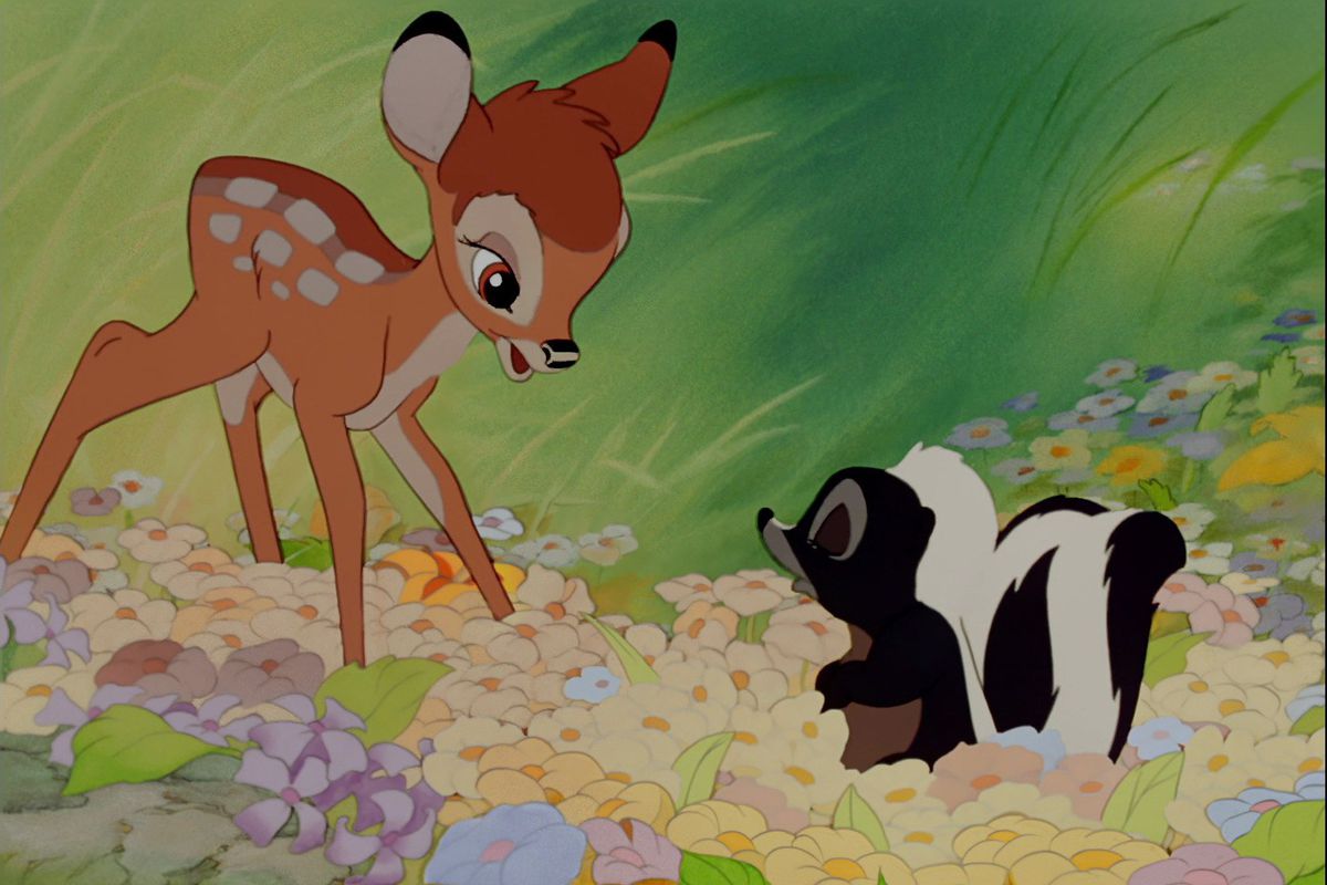 bambi looks at flower in a field of wildflowers