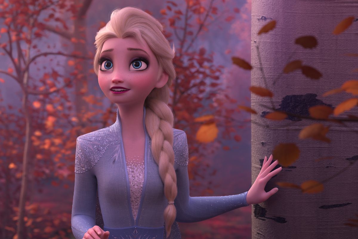 Elsa standing in a forest in the movie Frozen II.