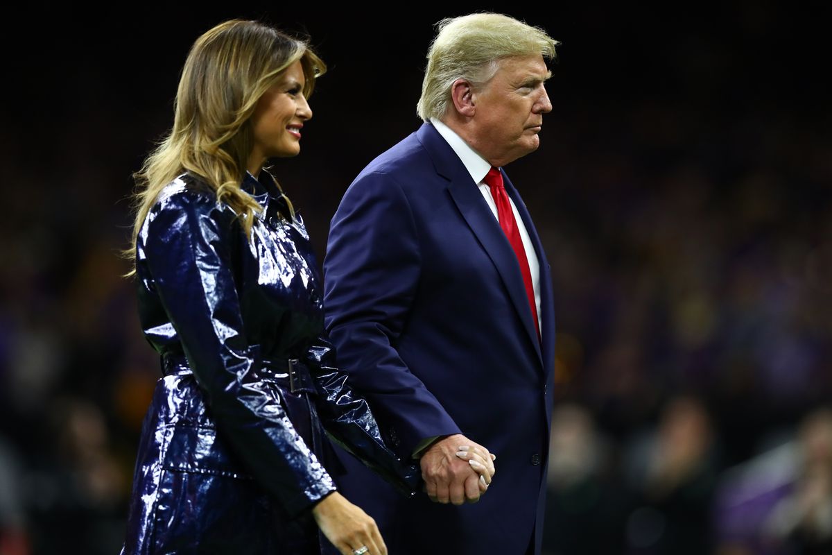 United States President Donald J. Trump and First Lady Melania Trump hold hands as they exit the field before the College Football Playoff national championship game between the Clemson Tigers and the LSU Tigers at Mercedes-Benz Superdome.