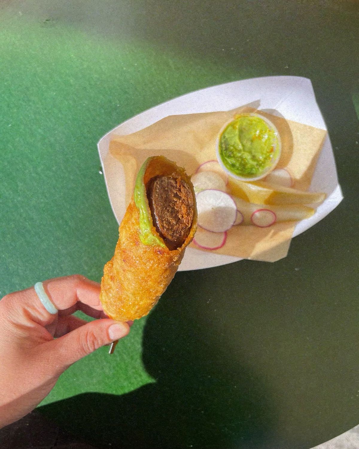 Corn dog held by a hand.