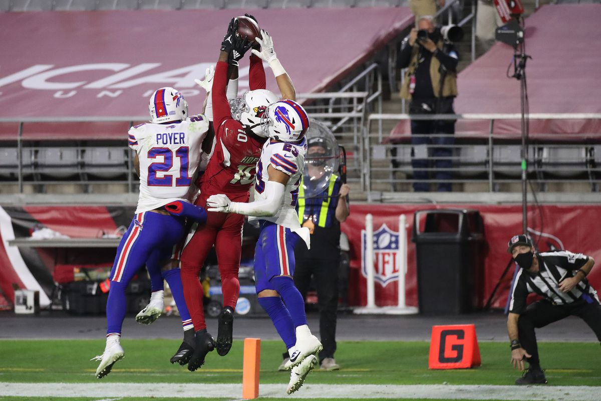 Wide receiver DeAndre Hopkins #10 of the Arizona Cardinals catches the game-winning touchdown pass as safety Jordan Poyer #21 and safety Micah Hyde #23 of the Buffalo Bills defend during the final seconds of the fourth quarter at State Farm Stadium on November 15, 2020 in Glendale, Arizona.