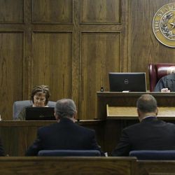 Judge Jason Cashon, back right, speaks to Eddie Ray Routh, left, and his lawyers Tim Moore, front right, and J. Warren St. John during a pretrial proceeding, Tuesday, Feb. 10, 2015, in Stephenville, Texas. The former Marine is accused of killing Navy SEAL sniper Chris Kyle and Kyle's friend Chad Littlefield at a gun range on Feb. 2, 2013. 