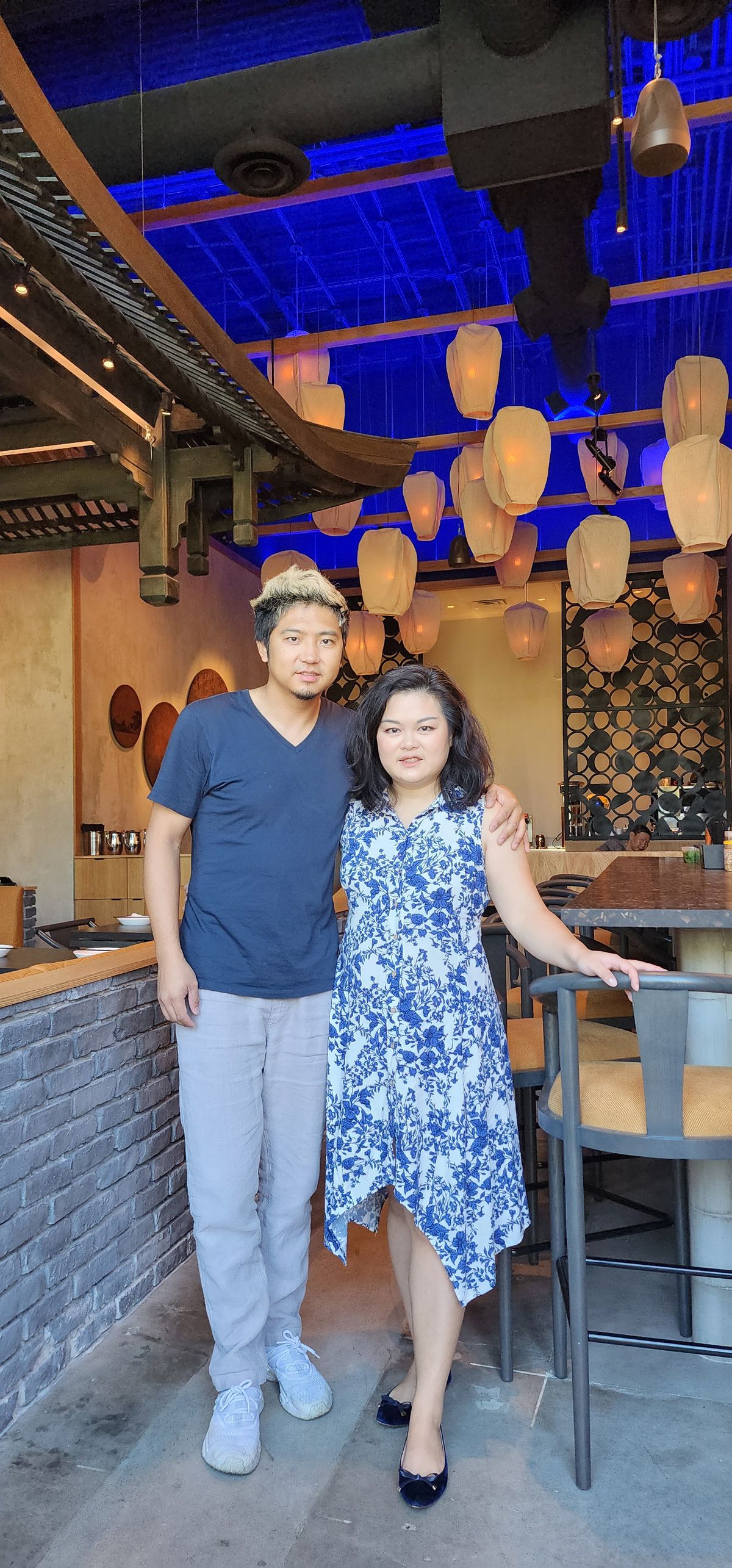 Owners Heng Chen and Cori Xiong standing in the dining room area of Mala Sichuan’s Heights location.
