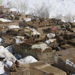 Afghans stand on the rooftops of their house after their village was hit by an avalanche in the Paryan district of Panjshir province, north of Kabul, Afghanistan, Friday, Feb. 27, 2015. The death toll from severe weather that caused avalanches and flooding across much of Afghanistan has jumped to more than 200 people, and the number is expected to climb with cold weather and difficult conditions hampering rescue efforts, relief workers and U.N. officials said Friday. 