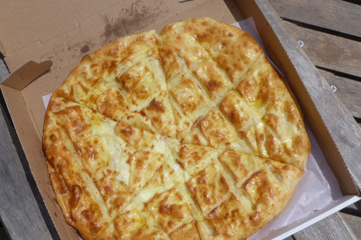 A browned flatbread in a box.