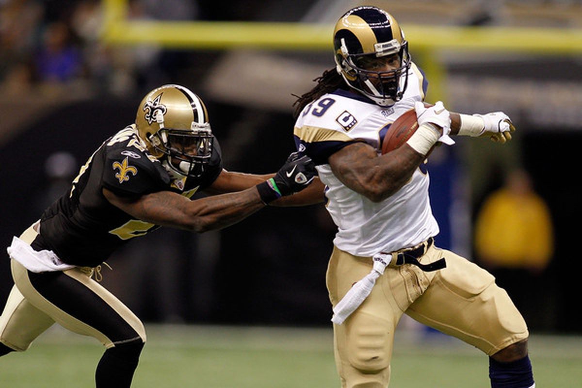 Steven Jackson #39 of the St. Louis Rams is tackled by Malcom Jenkins #27 of the New Orleans Saints.