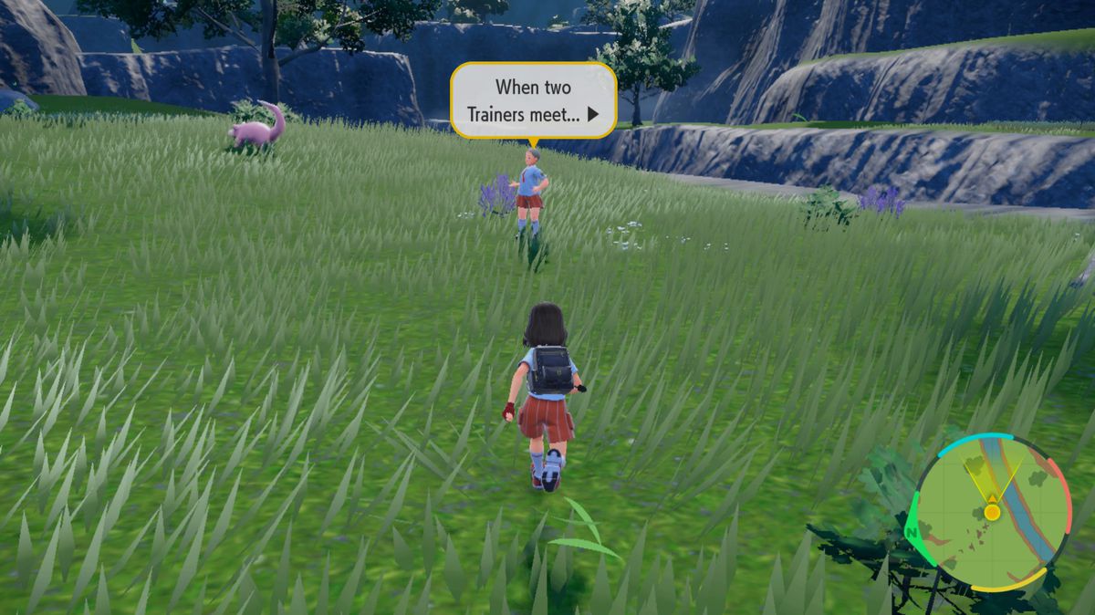 A Pokémon trainer runs towards another trainer in a grass field