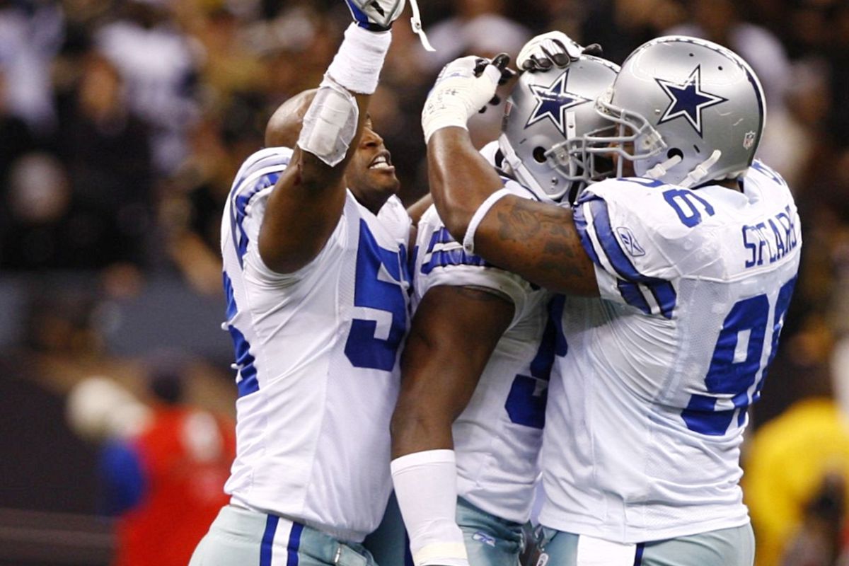 Bradie James #56, DeMarcus Ware #94 and Marcus Spears #96 celebrate after sack in 2009.