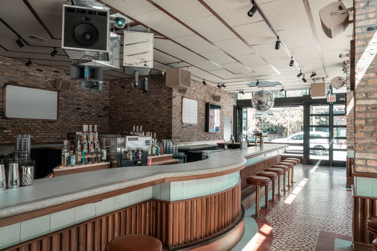 A long concrete bar inside a cocktail bar.