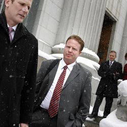 Attorney Nathan Crane, left, and his client Jeremy Johnson leave the Frank E. Moss federal courthouse after a change of plea hearing in Salt Lake City on Friday, Jan. 11, 2013. 