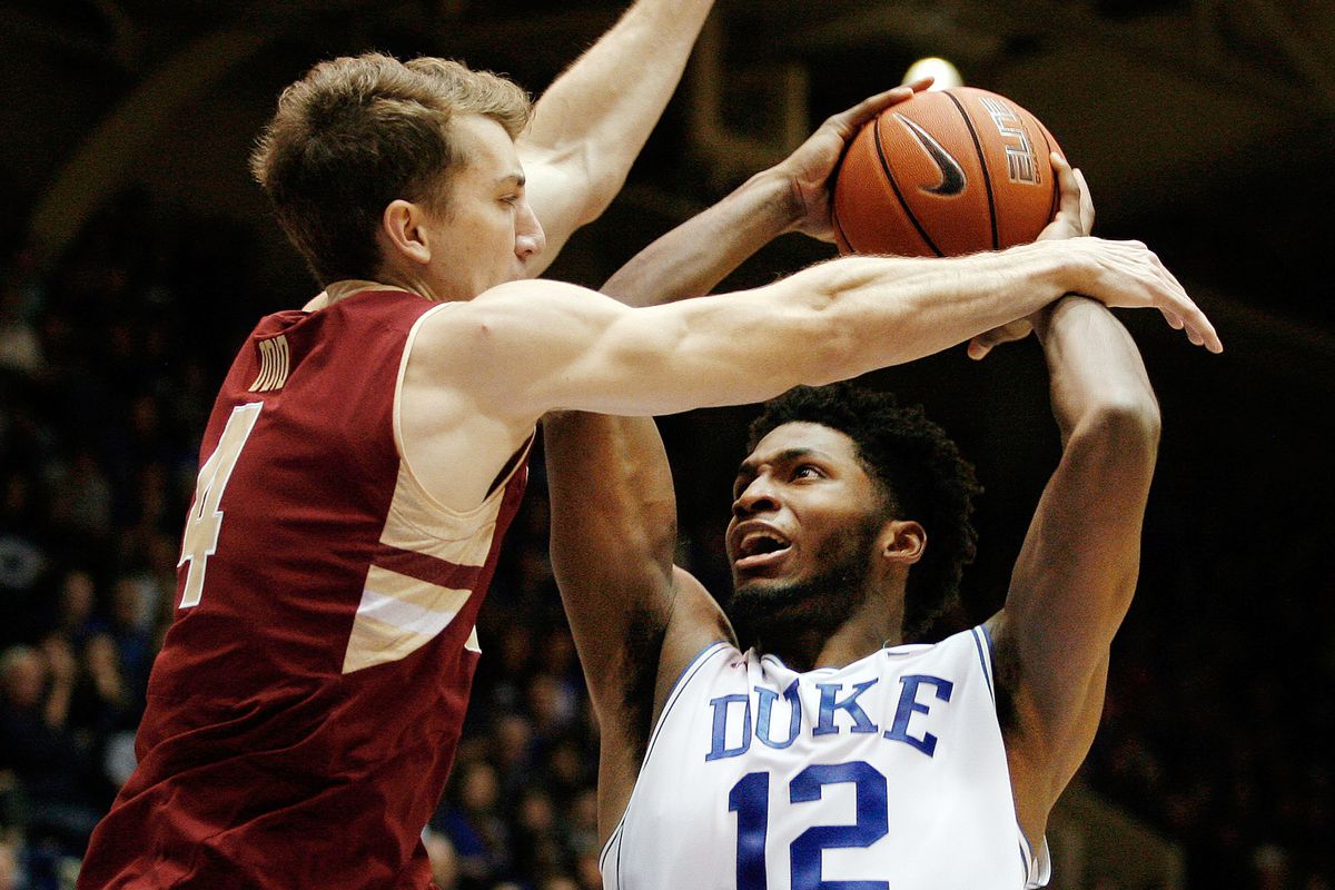 Jan 3, 2015; Durham, NC, USA; Duke Blue Devils forward Justise Winslow (12) is fouled by Boston College Eagles forward Eddie Odio (4) in their game at Cameron Indoor Stadium. 