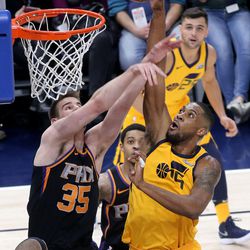Phoenix Suns forward Dragan Bender (35) guards Utah Jazz forward Derrick Favors (15) as he shoots during a basketball game at the Vivint Smart Home Arena in Salt Lake City on Wednesday, Feb. 14, 2018.