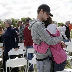 Patrick Weaver hugs a friend after an outdoor service for the First Baptist Church in a field Sunday, April 21, 2013, four days after an explosion at a fertilizer plant in West, Texas. Weaver's home was destroyed after a massive explosion at the West Fertilizer Co. Wednesday night that killed 14 people and injured more than 160. 