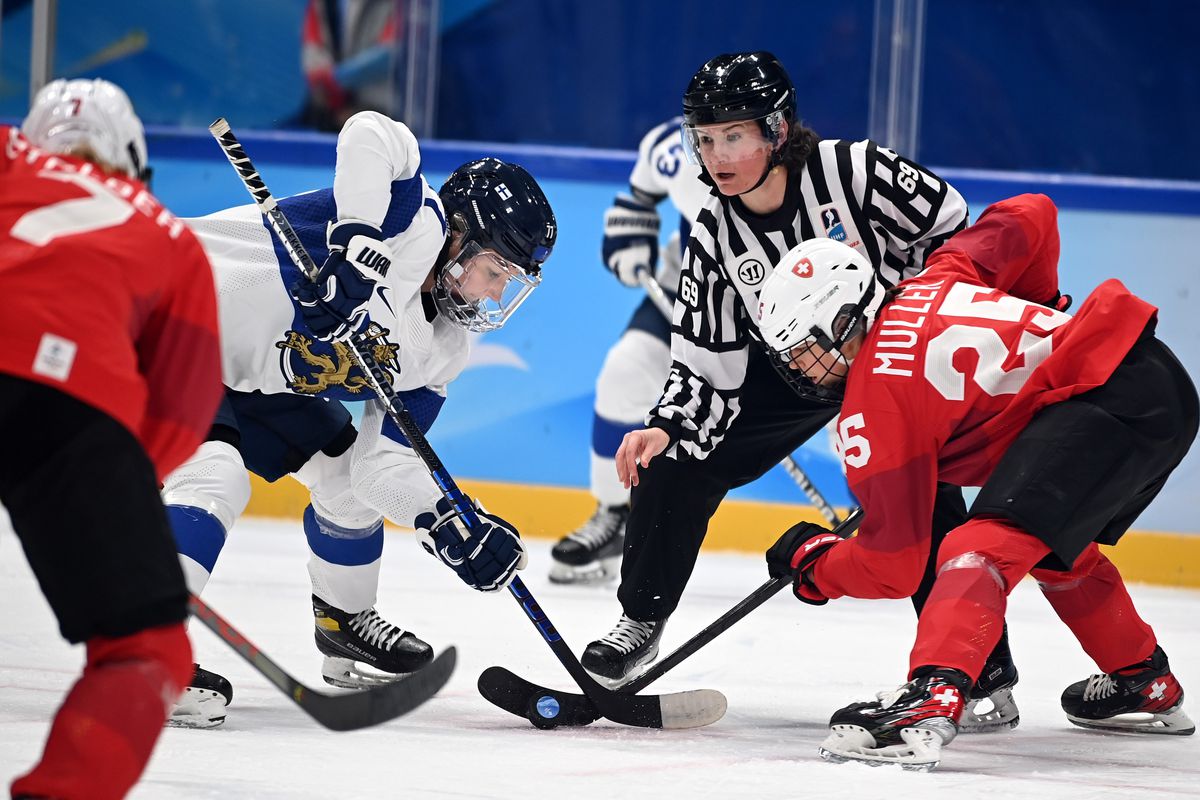 Alina Muller R of Switzerland vies with Susanna Tapani of Finland during the ice hockey women’s Group A match between Switzerland and Finland at National Indoor Stadium in Beijing, capital of China, Feb. 7, 2022.