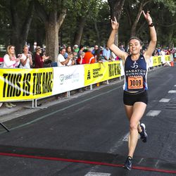 Jocelyn Todd crosses the finish line as she wins the Deseret News 10K race that finished at Liberty Park in Salt Lake City on Tuesday, July 24, 2018.