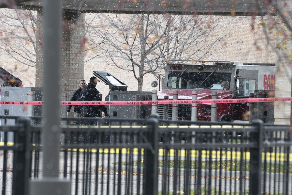 Police investigate Monday where two armored truck guards were shot at a Bank of America branch in Chatham.&nbsp;