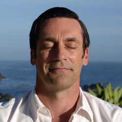 This image released by AMC shows Jon Hamm as Don Draper in a scene from the final episode of "Mad Men." Seemingly a broken man, Don Draper got his groove back while meditating at a yoga camp. In the finale, he linked Coca-Cola with world peace in a warm-and-fuzzy TV commercial. The idea brought Don back to the big time, demonstrating he was truly The Real Thing. (AMC via AP)