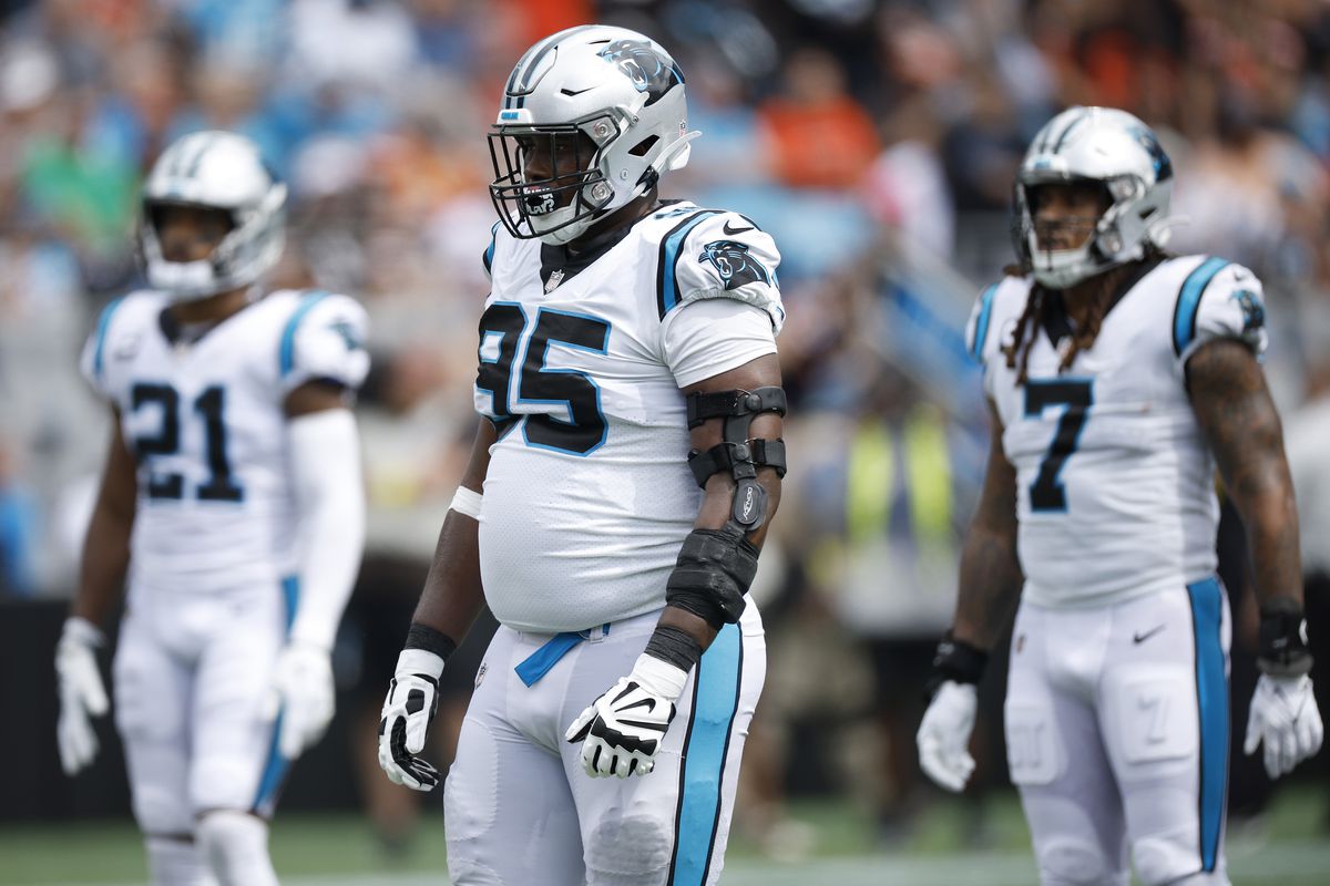 Defensive tackle Derrick Brown #95, linebacker Shaq Thompson #7, and safety Jeremy Chinn #21 of the Carolina Panthers look on during the first half of their NFL game against the Cleveland Browns at Bank of America Stadium on September 11, 2022 in Charlotte, North Carolina.