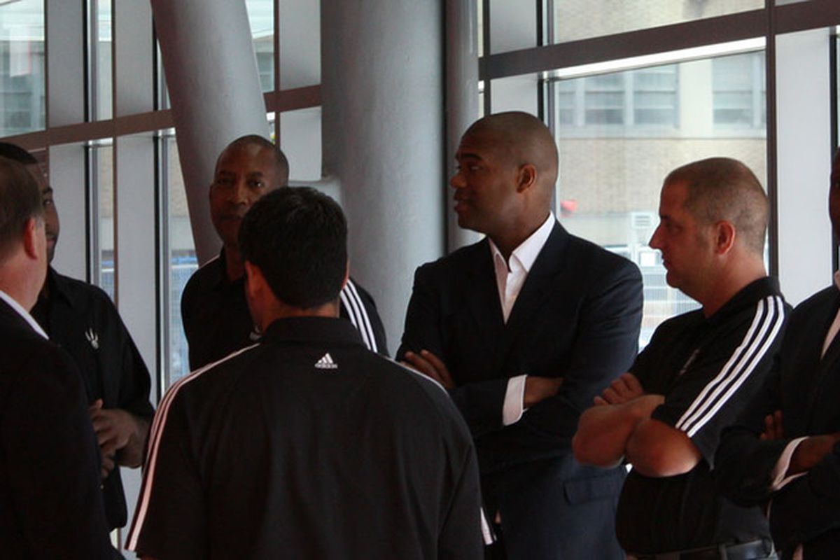 Raptors coaches, assistants, and scouts huddle together to talk about Media Day.  