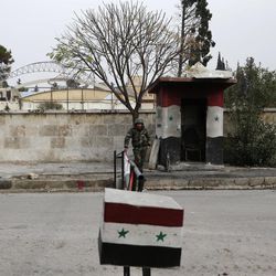 In this picture taken Monday, Dec. 5, 2016, a Syrian soldier stands guard at a checkpoint in western Aleppo, Syria. A Syrian war monitoring group says government forces have captured large parts of Aleppo's central-eastern al-Shaar neighborhood from rebels. The Britain-based Syrian Observatory for Human Rights says government forces took most of the once-populous neighborhood Tuesday following intense clashes. 